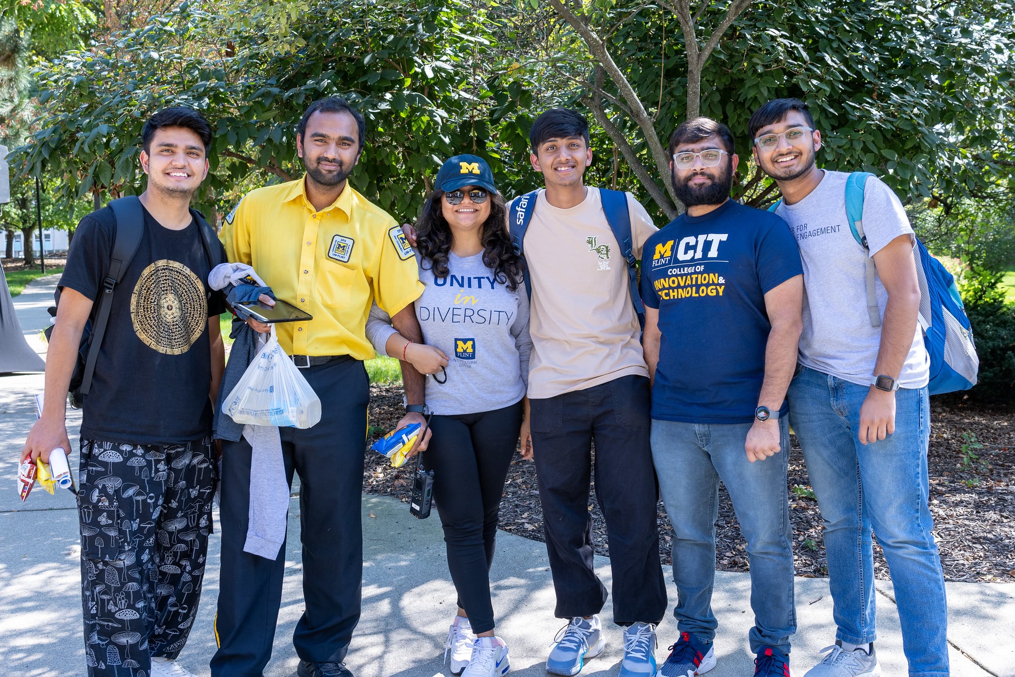 Group of UM-Flint students posing together outdoors.