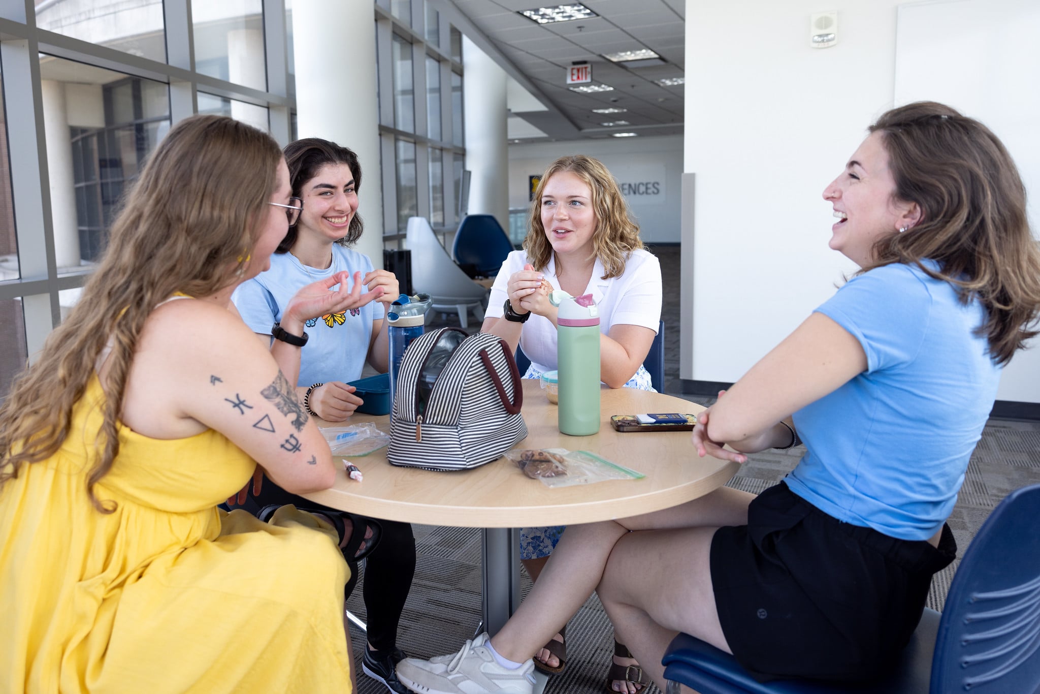 UM-Flint Students talking at a table