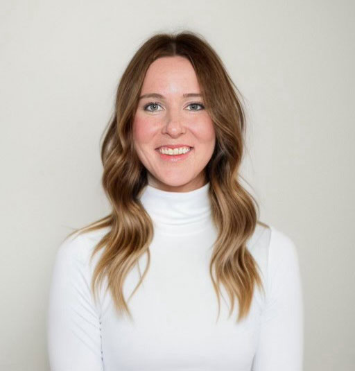 Tiffany H. smiling in a white turtleneck against a light background.