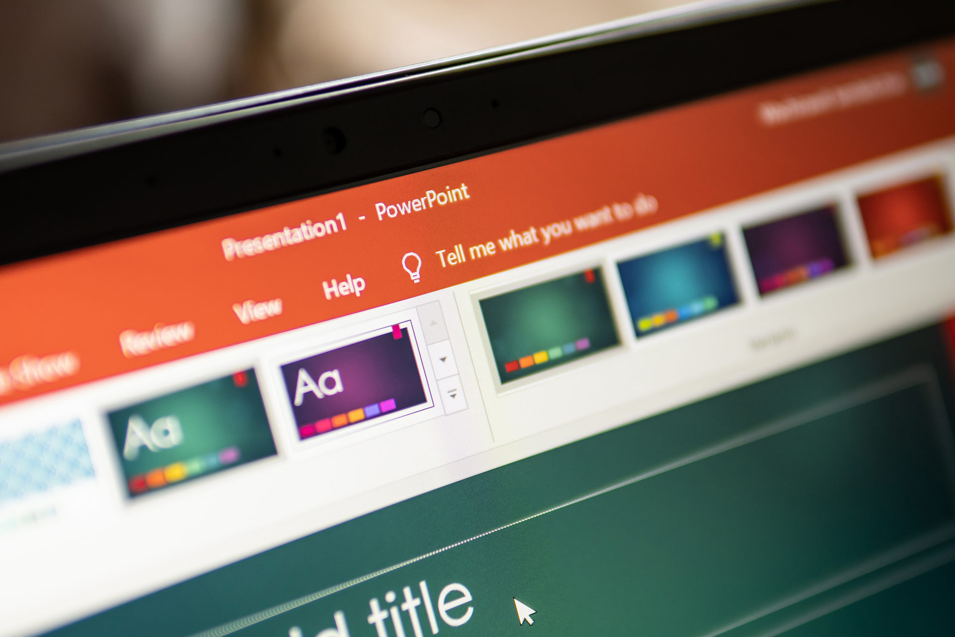 Screenshot of a PowerPoint interface showing a presentation titled "Presentation1," with design options and a blank slide.