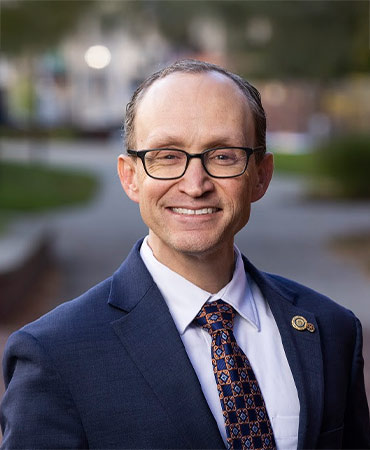 Man in a blue suit with glasses