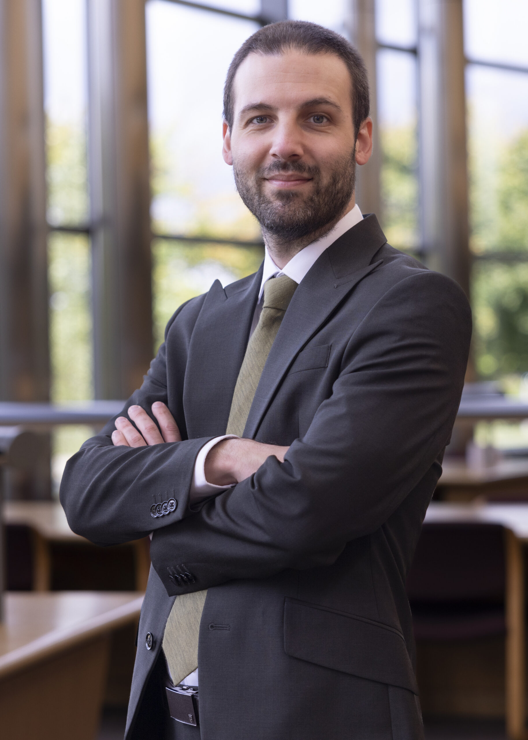 Portrait of a man with short brown hair in a suit