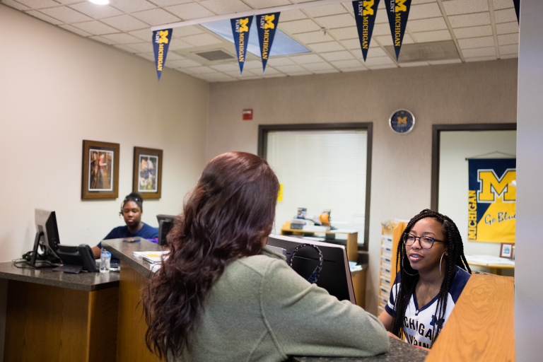 Three female workers talking in an office