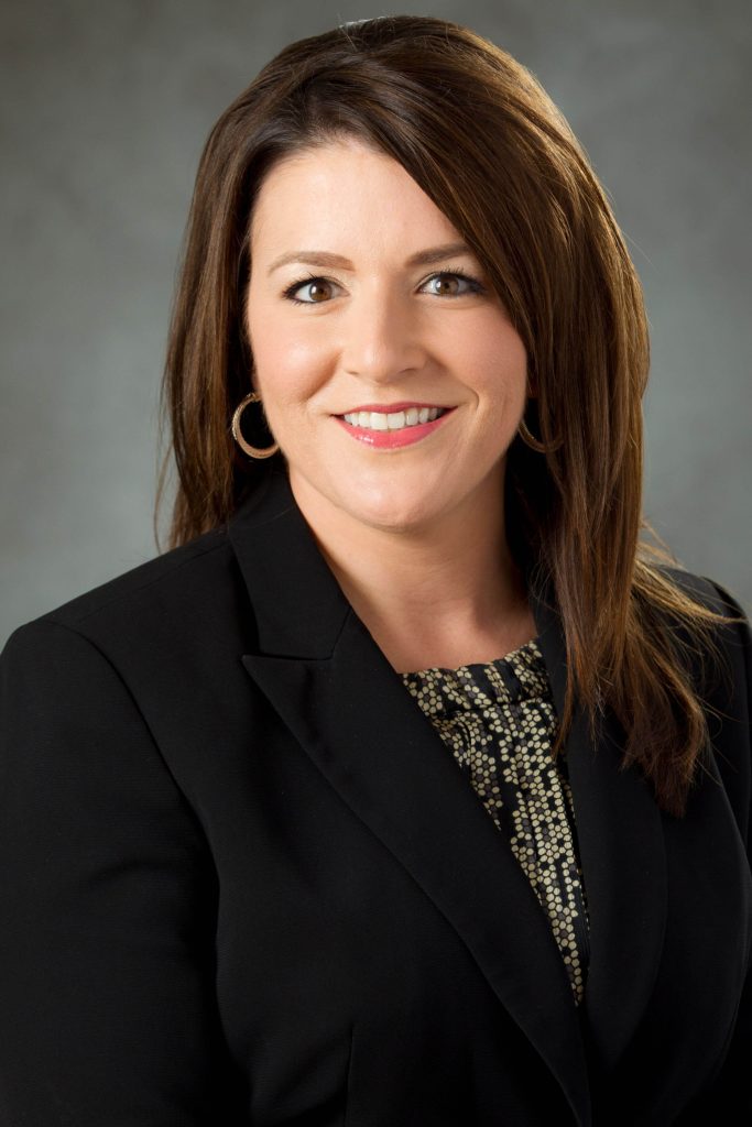 Portrait of a woman with brown hair in a black blazer