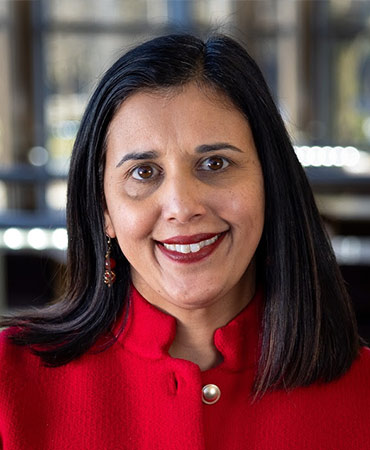 Portrait of a woman with dark hair in a red jacket