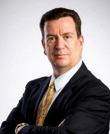 Portrait of a man with dark hair in a suit