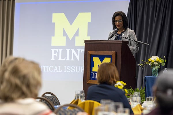a woman at a podium during a conference