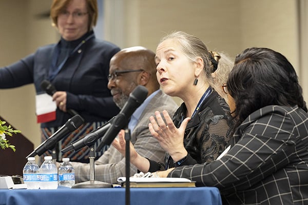 a woman on a panel speaking
