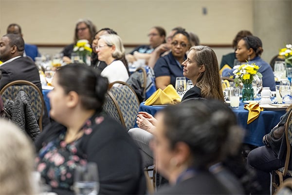 people at tables during a conference