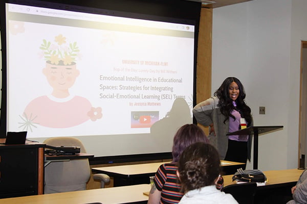 woman presenting on a large screen