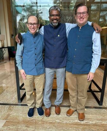 Three men taking a group photo