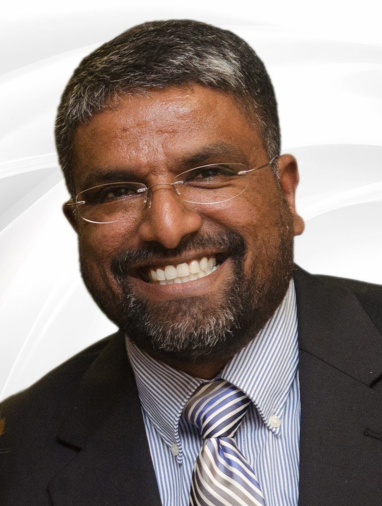 Portrait of a man with glasses in suit jacket and striped shirt and tie