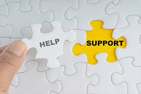 White puzzle pieces with one that says "help" to go over the empty yellow spot that says "support"