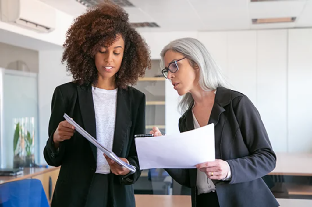 two business women reviewing paperwork
