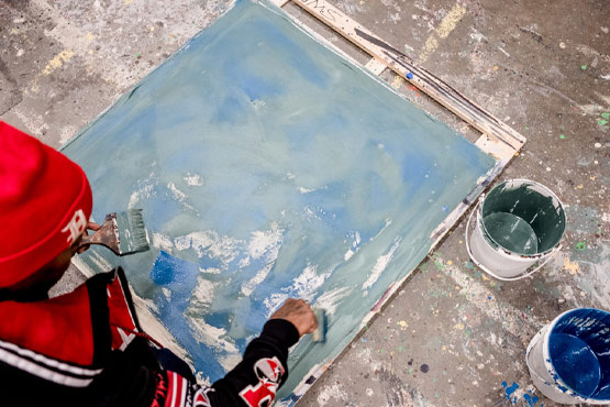 Person painting on canvas.