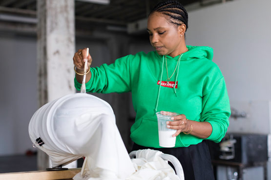 Ash Arder working in an art studio.