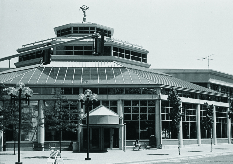 Exterior of the Water Street Pavilion, a circular glass and brick building.