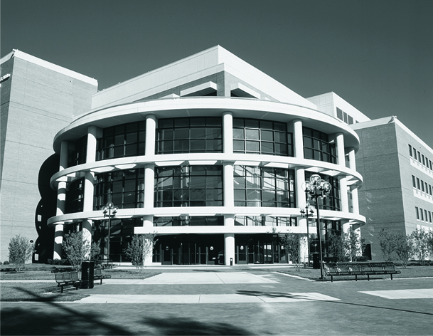 Exterior of the William S. White Building, a modern circular building with large windows.