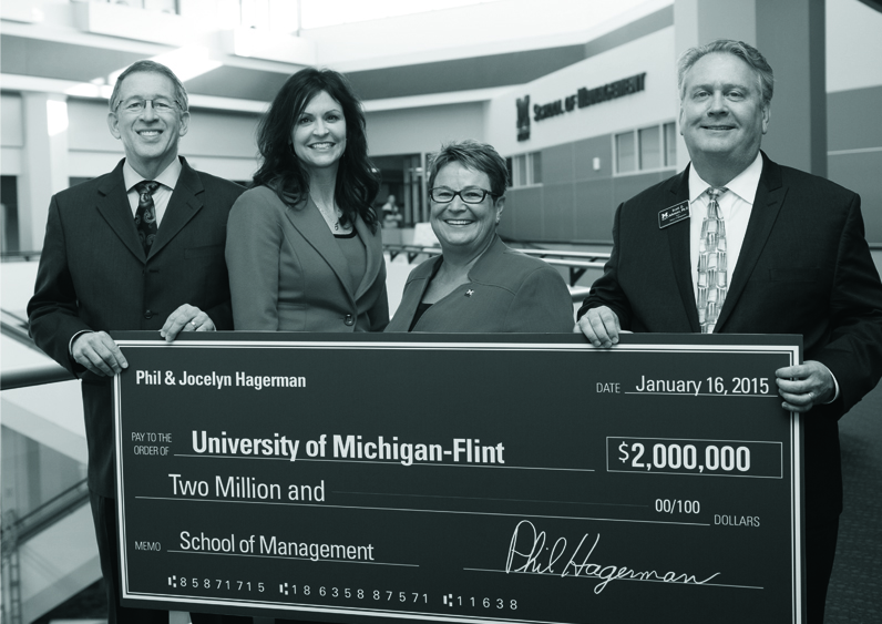 University officials holding an oversized check for a $2 million donation from Phil and Jocelyn Hagerman.